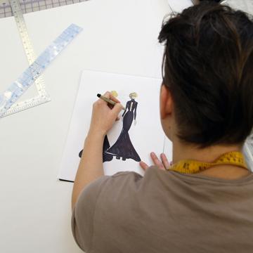 A student sketches a dress design concept