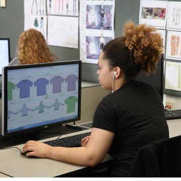 A student works on patterns at a computer terminal.