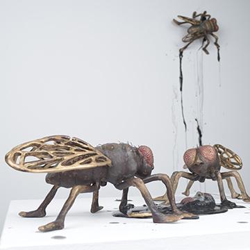 Metal sculptures of giant flies