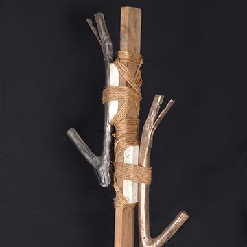 Sculpture of metal branches bound to a wooden stick