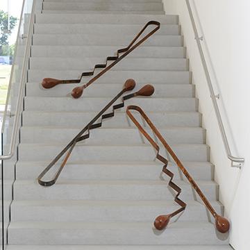 Giant sculpture of bobby pins displayed on the steps inside the Nerman Museum