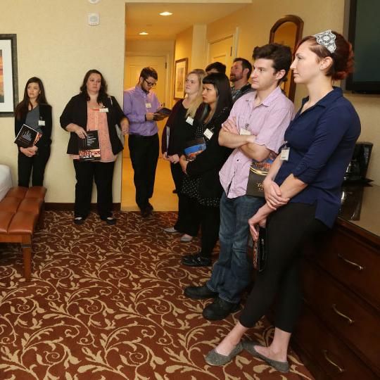 Students listening to a lecture in a hotel room