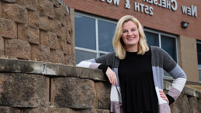 Megan Segraves poses in front of New Chelsea Elementary School at 25th and Wood in Kansas City, Kansas.